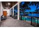 Beautiful backyard with outdoor seating and a gorgeous in ground pool overlooking the channel at twilight at 1100 Monterey Ne Blvd, St Petersburg, FL 33704