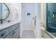Bathroom featuring blue tiled shower, decorative floor tiles, and modern hardware at 1100 Monterey Ne Blvd, St Petersburg, FL 33704