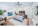 Bright bedroom with a statement headboard, ceiling fan, and light hardwood floors at 1100 Monterey Ne Blvd, St Petersburg, FL 33704