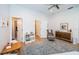 Bright bedroom with wood floors, area rug, neutral chair, and a small table at 1100 Monterey Ne Blvd, St Petersburg, FL 33704