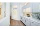 Bright Butler's Pantry with white cabinetry, a tile backsplash, and modern fixtures at 1100 Monterey Ne Blvd, St Petersburg, FL 33704