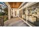 An exterior patio features brick flooring, ceiling fan, and sliding glass doors that lead to a living room at 1100 Monterey Ne Blvd, St Petersburg, FL 33704