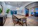 Spacious dining room with a large wood table, stylish chairs, and modern lighting fixture at 1100 Monterey Ne Blvd, St Petersburg, FL 33704