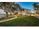 Stunning waterfront home featuring a manicured lawn and mature trees at 1100 Monterey Ne Blvd, St Petersburg, FL 33704