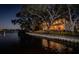 Luxury waterfront home at night with private boat dock and waterfront views at 1100 Monterey Ne Blvd, St Petersburg, FL 33704
