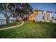 Luxury home on waterfront property featuring a covered patio and manicured lawn at 1100 Monterey Ne Blvd, St Petersburg, FL 33704