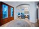 Bright foyer featuring hardwood floors, arched doorways, high ceilings, a modern chandelier, and view of the living room at 1100 Monterey Ne Blvd, St Petersburg, FL 33704