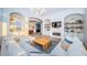 Bright living room featuring a fireplace, modern chandelier, and comfortable seating arrangement at 1100 Monterey Ne Blvd, St Petersburg, FL 33704