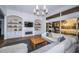Bright living room features built-in shelving, a fireplace, and oversized sliding glass doors with sunset water view at 1100 Monterey Ne Blvd, St Petersburg, FL 33704
