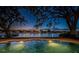 Backyard pool at dusk with waterfront views and in-pool lighting at 1100 Monterey Ne Blvd, St Petersburg, FL 33704