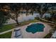 Backyard features a private pool, waterfront view, mature trees, and an outdoor lounge area at 1100 Monterey Ne Blvd, St Petersburg, FL 33704