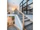 View of modern staircase with carpeted steps and black metal railing and decorative window at 1100 Monterey Ne Blvd, St Petersburg, FL 33704