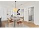 Open dining area near bathroom, featuring hardwood floors and modern lighting at 1001 E New Orleans Ave, Tampa, FL 33603