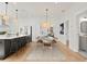 Open dining area adjacent to the kitchen, featuring hardwood floors and modern lighting at 1001 E New Orleans Ave, Tampa, FL 33603