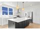 Modern kitchen with stainless steel appliances, subway tile backsplash, and an island with seating at 1001 E New Orleans Ave, Tampa, FL 33603