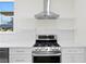 Modern kitchen featuring stainless steel range and hood at 1001 E New Orleans Ave, Tampa, FL 33603