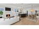 Open-concept living room boasts a fireplace, modern kitchen with stainless steel appliances, and a dining area at 1001 E New Orleans Ave, Tampa, FL 33603