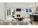 Comfortable living room with fireplace, television, view to the outside, and open kitchen at 1001 E New Orleans Ave, Tampa, FL 33603