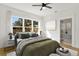 Bright main bedroom featuring a ceiling fan, large window, and ensuite bathroom at 1001 E New Orleans Ave, Tampa, FL 33603