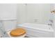 Bathroom with bathtub, toilet and white tile at 1005 Greenleaf Way, Tarpon Springs, FL 34689