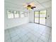 Bright sunroom with tile floors and sliding glass doors leading to the backyard at 1005 Greenleaf Way, Tarpon Springs, FL 34689