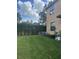 Small grassy backyard with a privacy fence and AC unit at 10235 Villa Palazzo Ct, Tampa, FL 33615