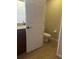 Small half bathroom with toilet and vanity at 10235 Villa Palazzo Ct, Tampa, FL 33615