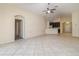 Spacious living room with tile flooring and a view into the kitchen at 12320 Ballentrae Forest Dr, Riverview, FL 33579