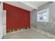 Small bedroom with red painted wall and tiled floor at 7620 Dennison Dr, Tampa, FL 33619