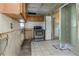 Kitchen needing renovation with wood cabinets and appliances at 7620 Dennison Dr, Tampa, FL 33619