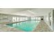 Indoor community pool with tiled flooring and ample seating at 39650 Us 19 N # 855, Tarpon Springs, FL 34689