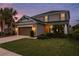 Two-story house with a brown garage door and landscaping at 8011 Marbella Creek Ave, Tampa, FL 33625