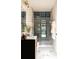 Chic bathroom with tiled shower, modern vanity, and marble-look floor at 7176 S Shore Dr, South Pasadena, FL 33707