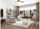 Bright home office with ample natural light, sleek furniture, and a stylish bookcase at 7176 S Shore Dr, South Pasadena, FL 33707