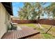 Fenced backyard with wooden deck and hammock at 1312 E Louise Ave, Tampa, FL 33603