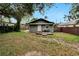 Cozy backyard with a small cottage, deck, and hammock at 1312 E Louise Ave, Tampa, FL 33603