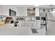 Modern white kitchen with quartz countertops and stainless steel appliances at 1312 E Louise Ave, Tampa, FL 33603