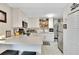 Modern white kitchen with quartz countertops and hexagon tile floor at 1312 E Louise Ave, Tampa, FL 33603