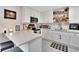 Modern white kitchen with quartz countertops and hexagon tile floor at 1312 E Louise Ave, Tampa, FL 33603