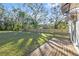 Spacious backyard with a wooden deck and lush greenery at 1919 E Hamilton Ave, Tampa, FL 33610