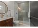 Elegant bathroom with a walk-in shower and wood vanity at 1919 E Hamilton Ave, Tampa, FL 33610