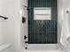 Clean bathroom with dark-blue tile shower surround at 1919 E Hamilton Ave, Tampa, FL 33610