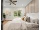 Bright bedroom with king bed, neutral tones, and large window at 1919 E Hamilton Ave, Tampa, FL 33610