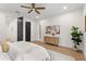 Main bedroom with plush bedding and built-in shelving at 1919 E Hamilton Ave, Tampa, FL 33610