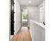 Bright hallway with hardwood floors and a view of bedroom at 1919 E Hamilton Ave, Tampa, FL 33610