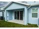 Covered patio with sliding glass doors and AC unit at 2509 Mario Way, Clearwater, FL 33761