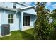 Light blue home with a back patio and air conditioning unit at 2509 Mario Way, Clearwater, FL 33761