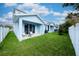 Private backyard with patio, lawn, and white vinyl fence at 2509 Mario Way, Clearwater, FL 33761