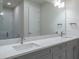 Modern bathroom featuring a double vanity and a large mirror at 2509 Mario Way, Clearwater, FL 33761