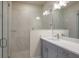 Elegant bathroom with double vanity, quartz countertop and a large walk-in shower at 2509 Mario Way, Clearwater, FL 33761